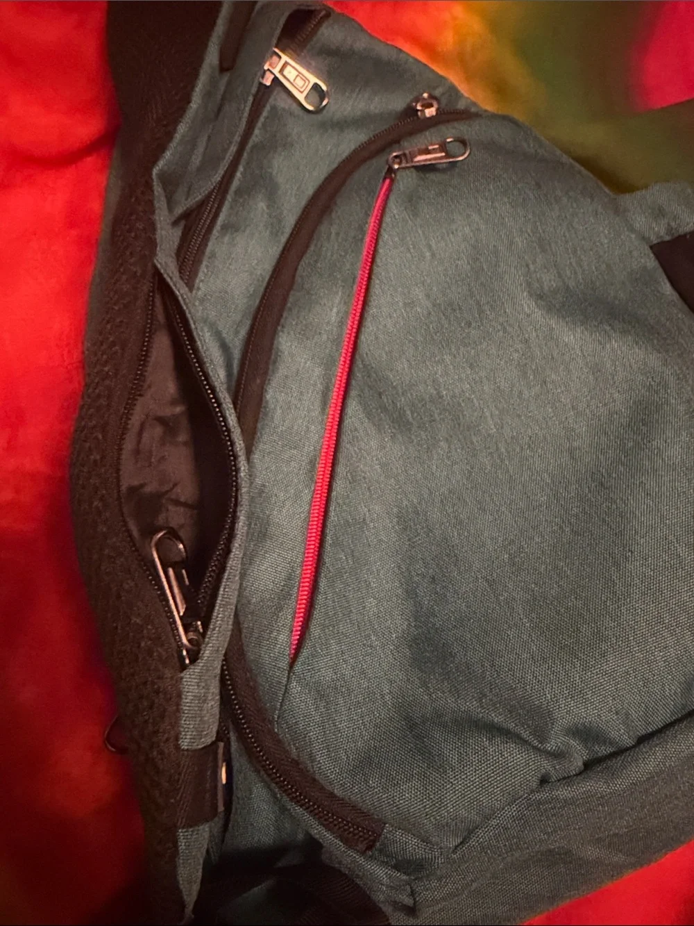 Teal Sling Backpack with Red Accent